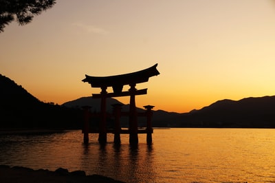 The silhouette of sunset terrace near the water
